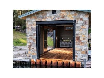 Mataverde SaferWood Decking in stone façade outdoor room on a private dock , fire retardant treated wood decking