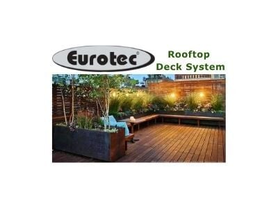  The Eurotec Rooftop Deck System logo above an image of a luxurious rooftop deck featuring Mataverde Ipe wood. This urban oasis includes garden boxes, built-in seating, and a privacy wall, all exemplifying premium rooftop decking. (photo courtesy or @tog-nyc.com)